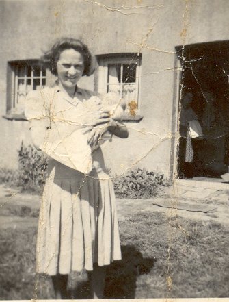 Totts-Lane-back-garden-in-the-1950s.-Eileen-Dunz-nee-Parker-with-baby-Mrs-Parker-in-doorway